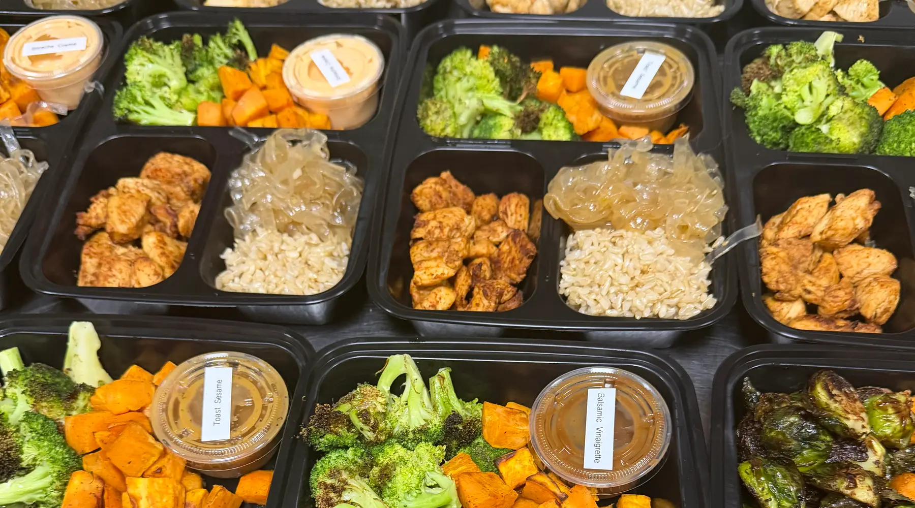 Brack's bowls with chicken, brown rice, roasted broccoli, sweet potatoes, and house sauces